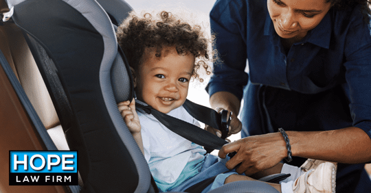 happy child being buckled into car seat